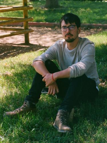 Andres sitting in a garden