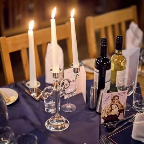 A menu card on the table decorated with portrait of Mākereti.