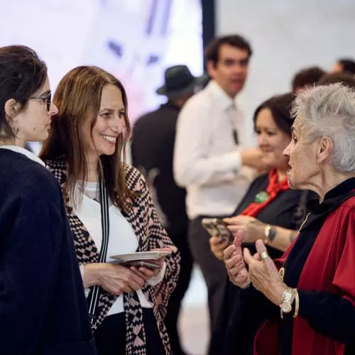 (Right) Emeritus Professor Ngahuia Te Awekotuku speaks with visitors from Aotearoa at the Weston Library. 