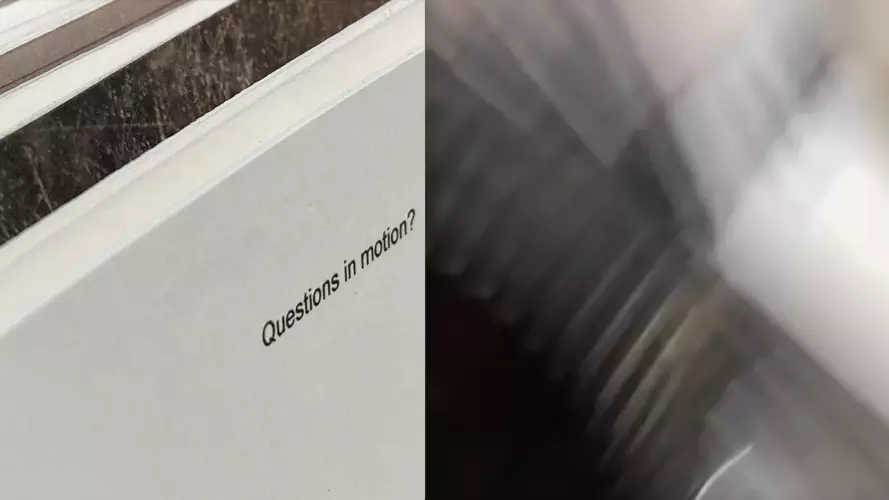 'questions in motion' typed on a card with blur