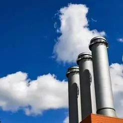 blue skies over 3 industrial chimneys