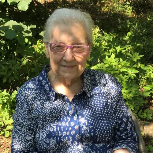 lidia sciama - an older woman sitting in a sunny garden