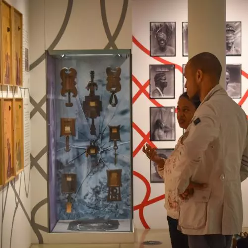 a man and a woman looking at exhibition together