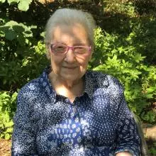 lidia sciama - an older woman sitting in a sunny garden