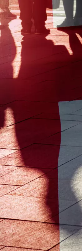 Peoples shadows on pavement with union jack overlay