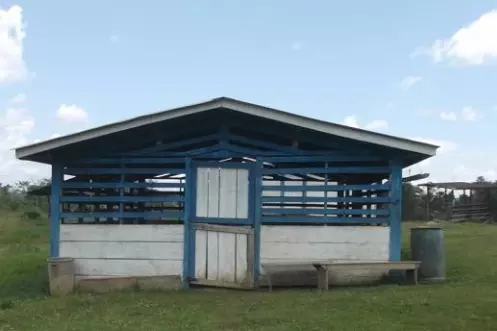 small wooden single story building painted blue and white